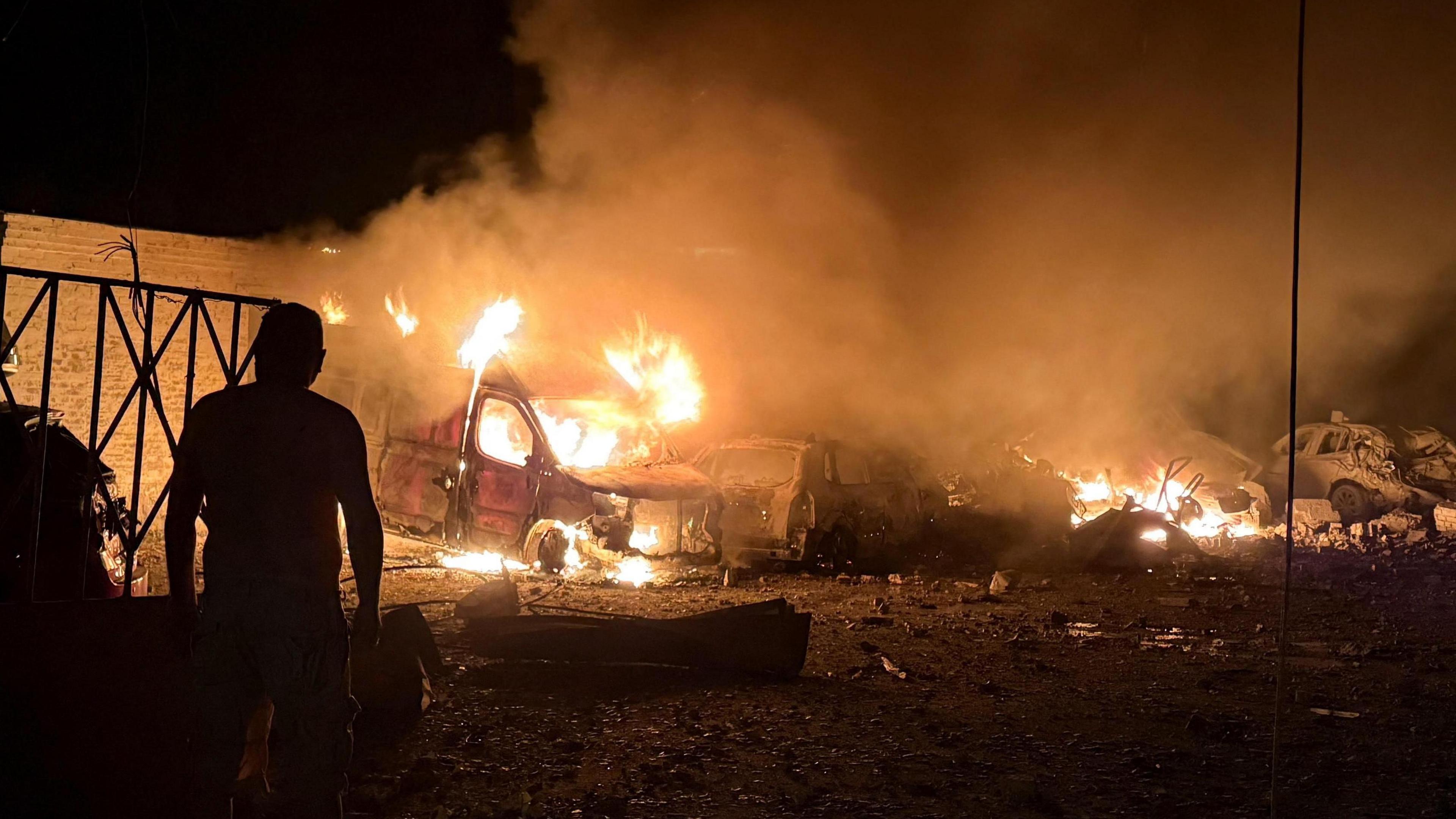 Image caption,Cars were left burning in Kyiv after the strikes