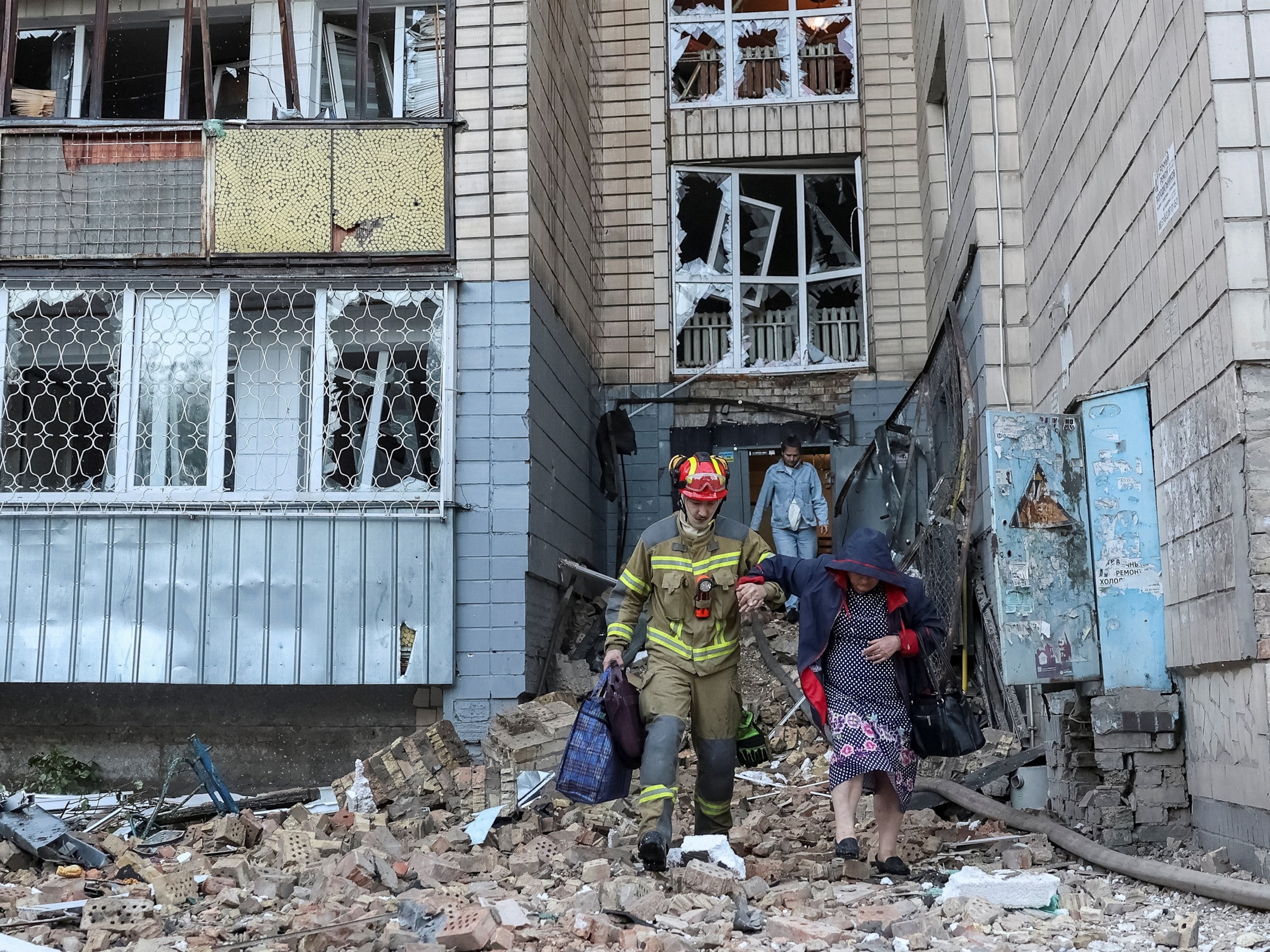 A rescuer evacuates a resident from an apartment building hit by Russian missile strike in Kyiv, Ukraine, on Aug. 20, 2026.Anatolii Stepanov/Reuters