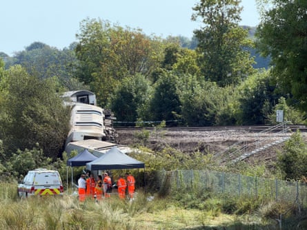 Workers plan the removal of the carriages on Wednesday in East Sussex.Photograph: Network Rail/PA