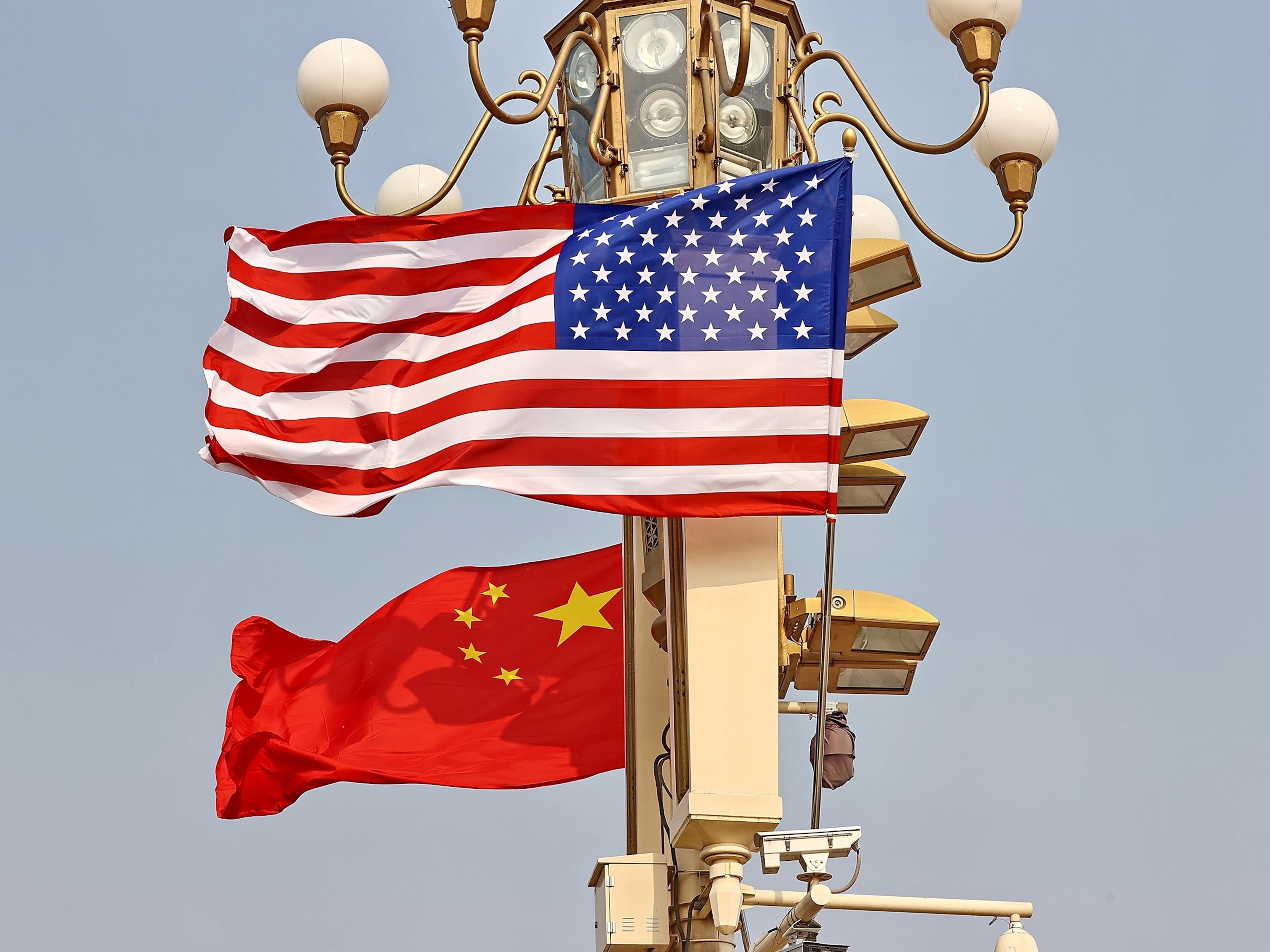 National flags of China and the U.S. hang from lamp posts on the Tiananmen Square on May 13, 2026 in Beijing, China.Wang Xin/VCG via Getty Image
