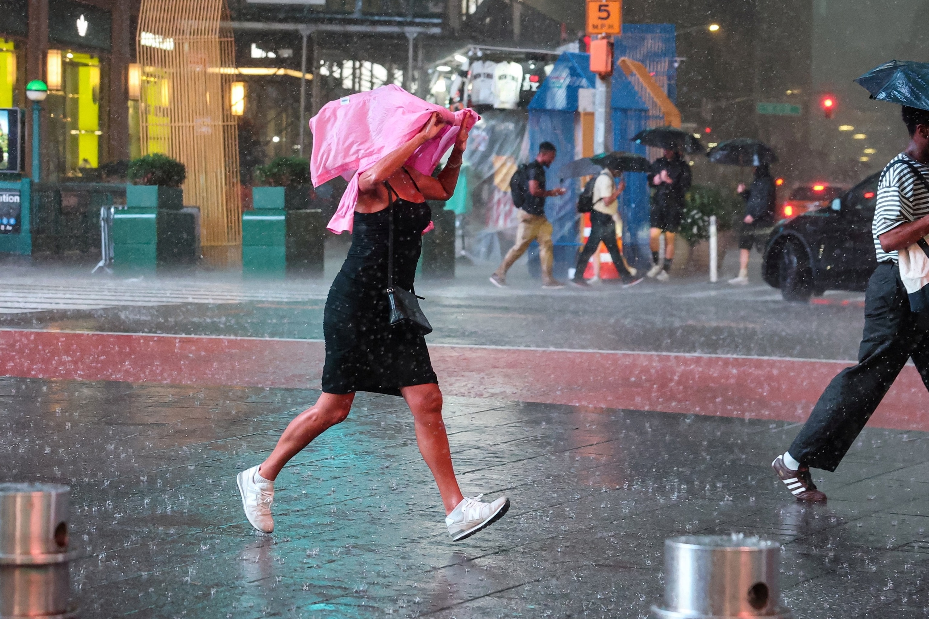 A woman runs through Times Square during a severe rainstorm in New York City, U.S., August 20, 2026.Brendan Mcdermid/Reuters