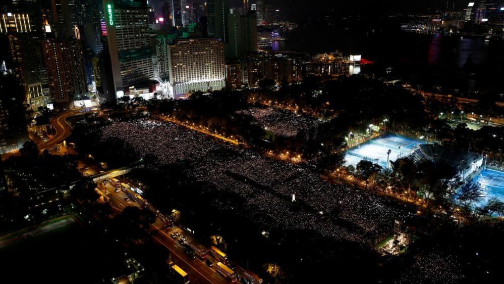Image caption,Thousands of people take part in a candlelight vigil at Victoria Park in Hong Kong to mark the 30th anniversary of Beijing's Tiananmen Square crackdown in 1989