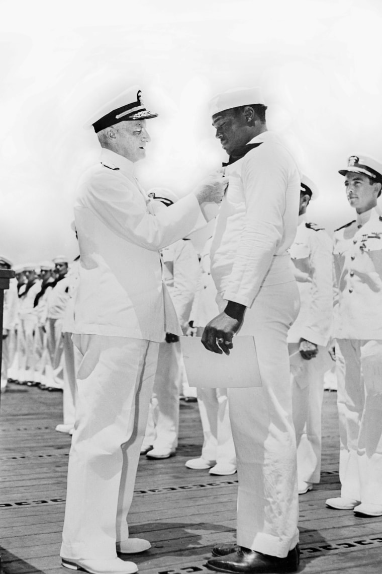 Admiral Chester W. Nimitz pinning Navy Cross on Doris "Dorie" Miller at ceremony aboard the USS Enterprise, Pearl Harbor, Hawaii, U.S. Office of War Information, on May 27, 1942.Universal History Archive / Universal Images Group via Getty Images file