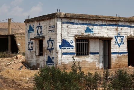 A graffito reading ‘Greater Israel’ and several Stars of David are painted on Palestinian property in the Jordan valley near the West Bank city of Tubas on 14 August 2026.Photograph: Atef Safadi/EPA