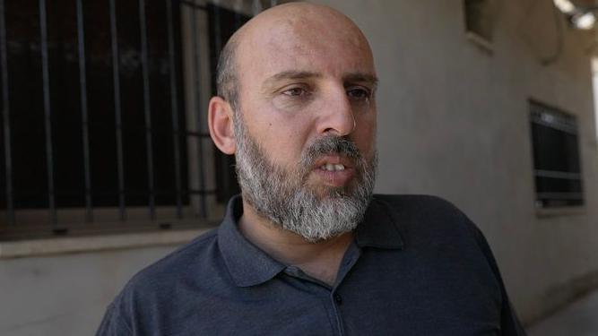 Image caption,Problems began even before most of the families moved in, schoolteacher Samer Jaber told the BBC