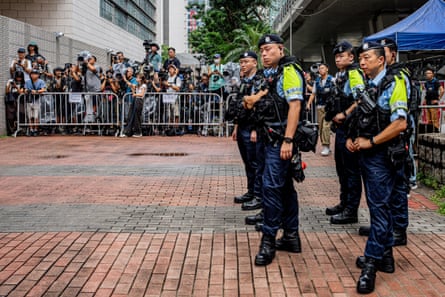 Police officers stand near the media area outside court ahead of the verdict.Photograph: Leung Man Hei/AFP/Getty Images