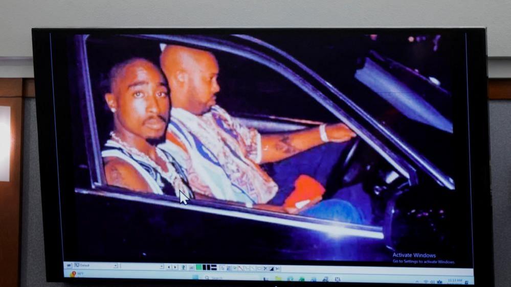 Image caption,A 1996 photo of rapper Tupac Shakur (L) and Marion "Suge" Knight displayed during the murder trial
