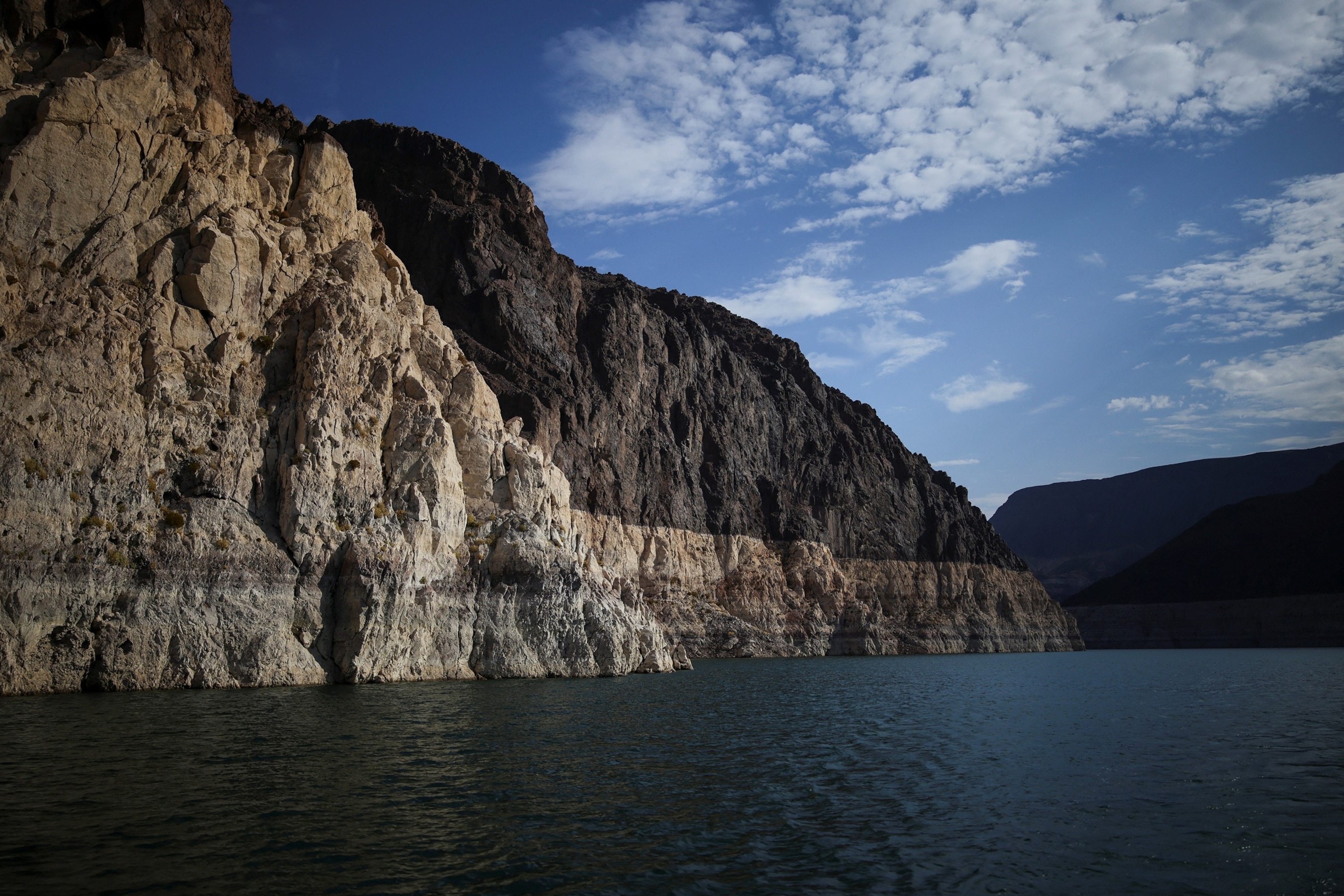 A mineral-stained bathtub ring marking previous water levels is visible along the shoreline of Lake Mead, the largest reservoir in the United States by water capacity, highlighting the long-term effects of drought and water demand on the Colorado River system, near Boulder City, Nevada, U.S., August 12, 2026.Daniel Cole/Reuters