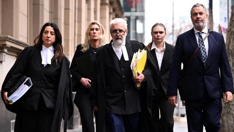 Image caption,Patterson's legal team, led by Richard Edney (centre)