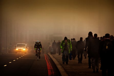 Commuters cross London Bridge on a smoggy morning in 2012.Photograph: Barry Lewis/Corbis/Getty Images