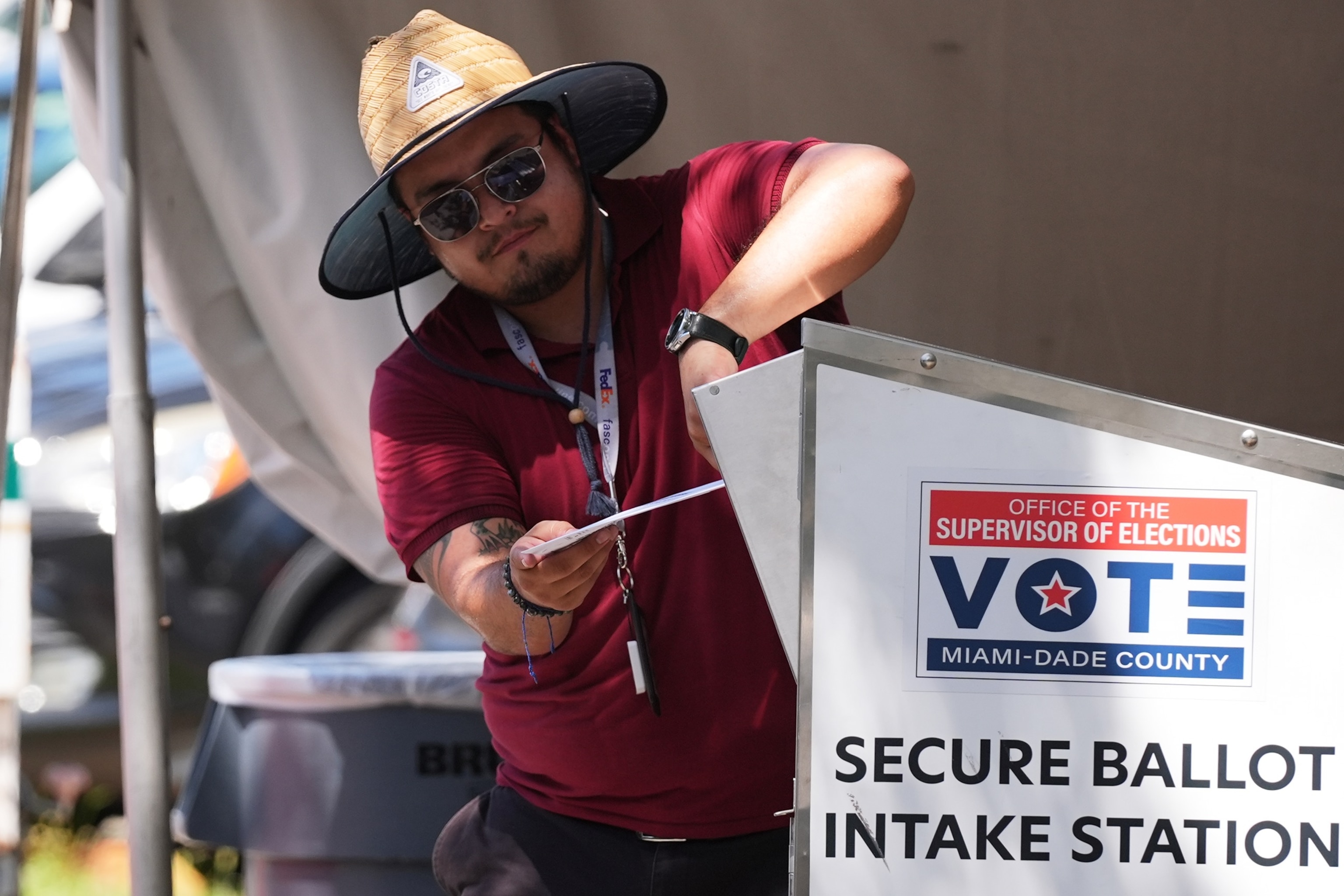 An election worker places a vote-by-mail ballot into a secure bin at the Miami-Dade County Supervisor of Elections Office during the Florida primary election in Doral, Fla., Tuesday, Aug. 18, 2026.Lynne Sladky/AP Photo
