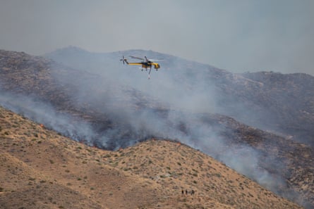 Fire crews and local agencies respond to a fast-moving wildfire on the dry hillsides outside Reno, Nevada, on Saturday.Photograph: Hale Irwin/NurPhoto/Shutterstock