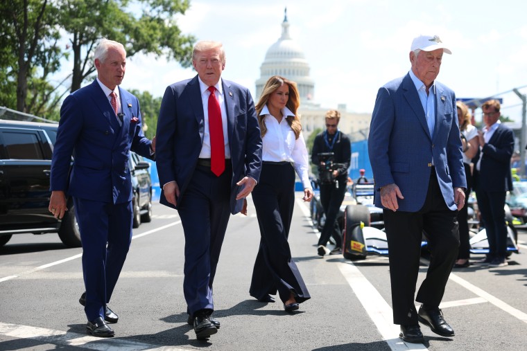 President Donald Trump and first lady Melania Trump greet drivers on the paddock Sunday.Kevin Dietsch / Getty Images
