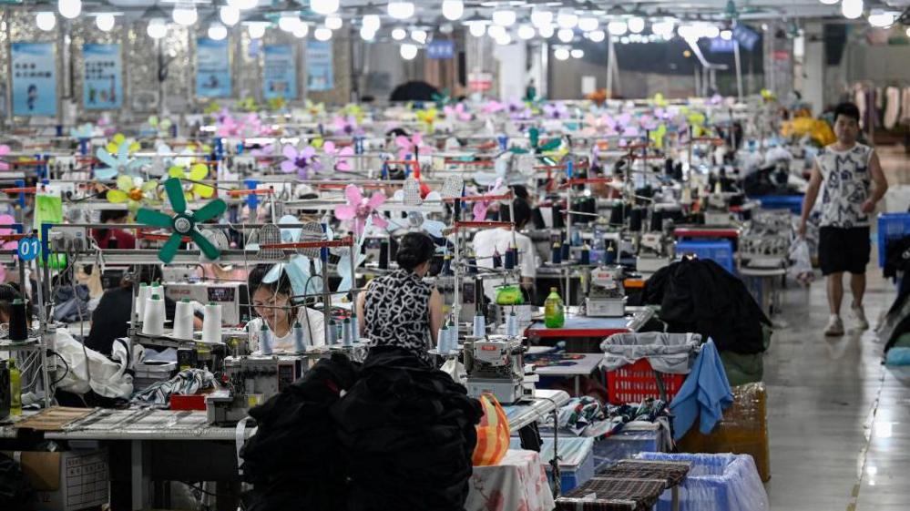 Image caption,Shein's fast-fashion clothes are backed by a network of factories in China
