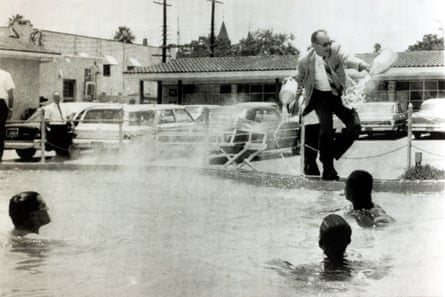 Motel manager James Brock dumps acid into a ‘whites only’ pool in Florida in 1964 after black and white demonstrators jumped in.Photograph: Rolls Press/Popperfoto/Getty Images