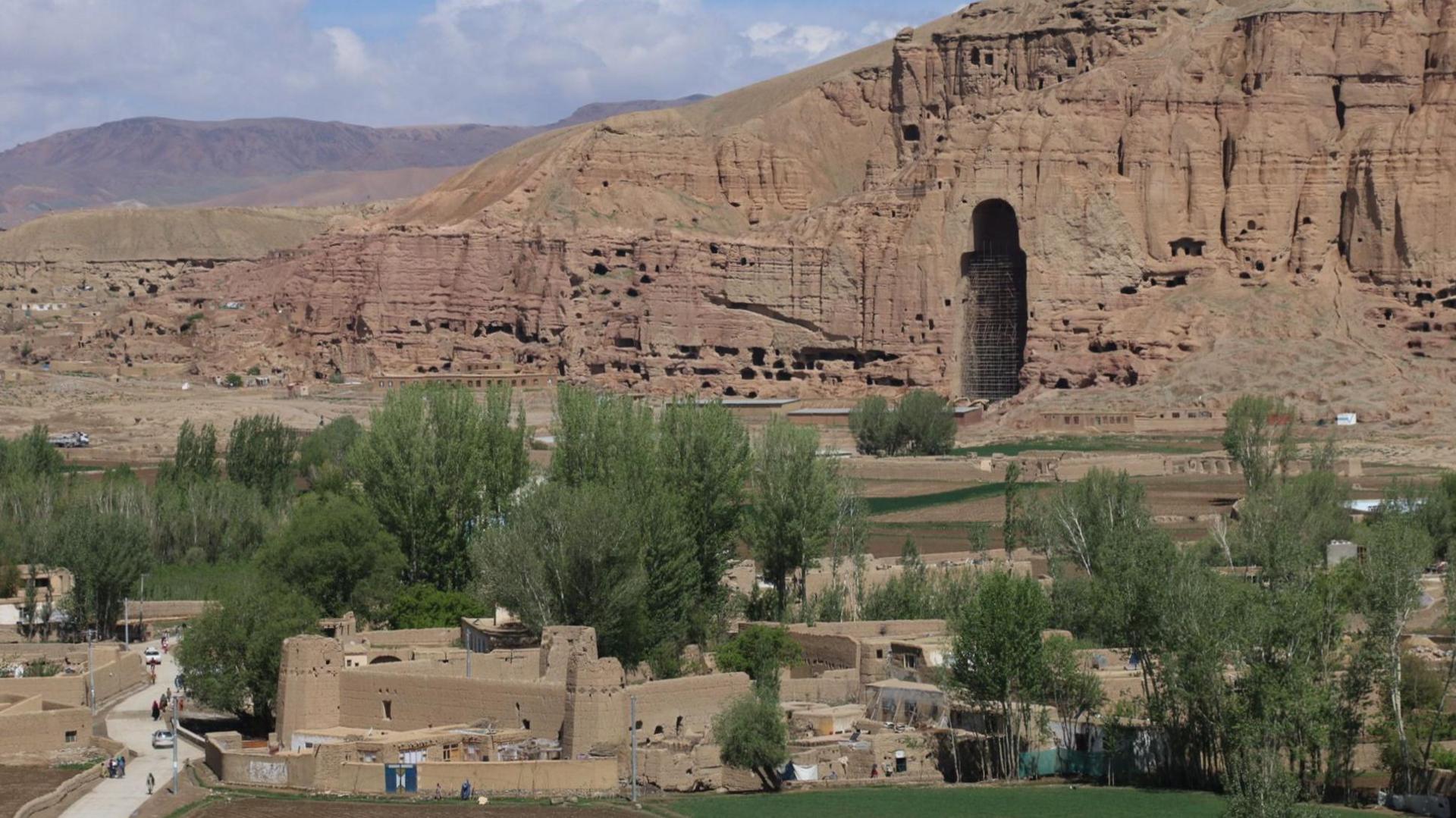 Image caption,A hole left by the destruction of one of the Buddha statues in Bamiyan -  Sarhadi says he destroyed it