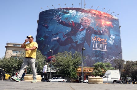 Iranians walk past an anti-US billboard featuring Donald Trump in Tehran.Photograph: Abedin Taherkenareh/EPA