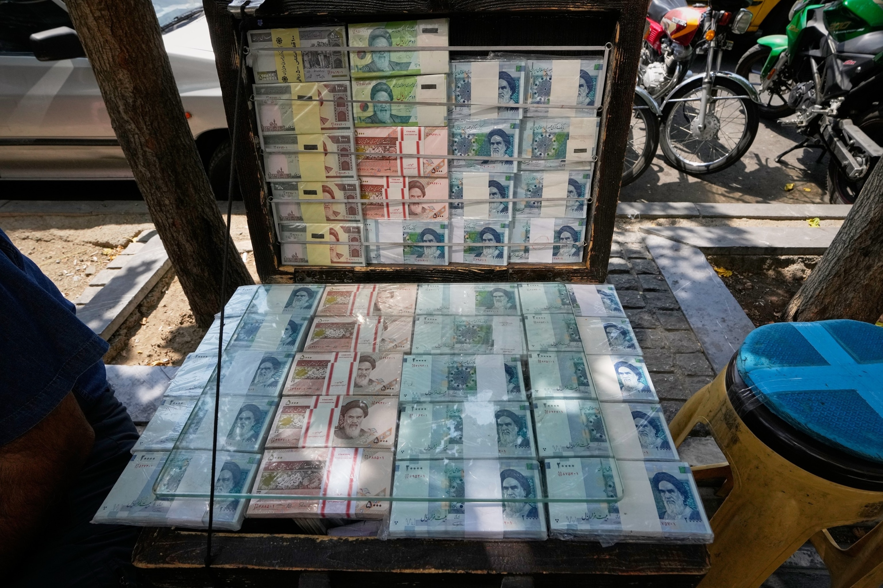 A money exchanger counts Iranian banknotes at Ferdowsi square, Tehran's go-to venue for foreign currency exchange, in downtown Tehran, Iran, Aug. 24, 2026.Vahid Salemi/AP Photo