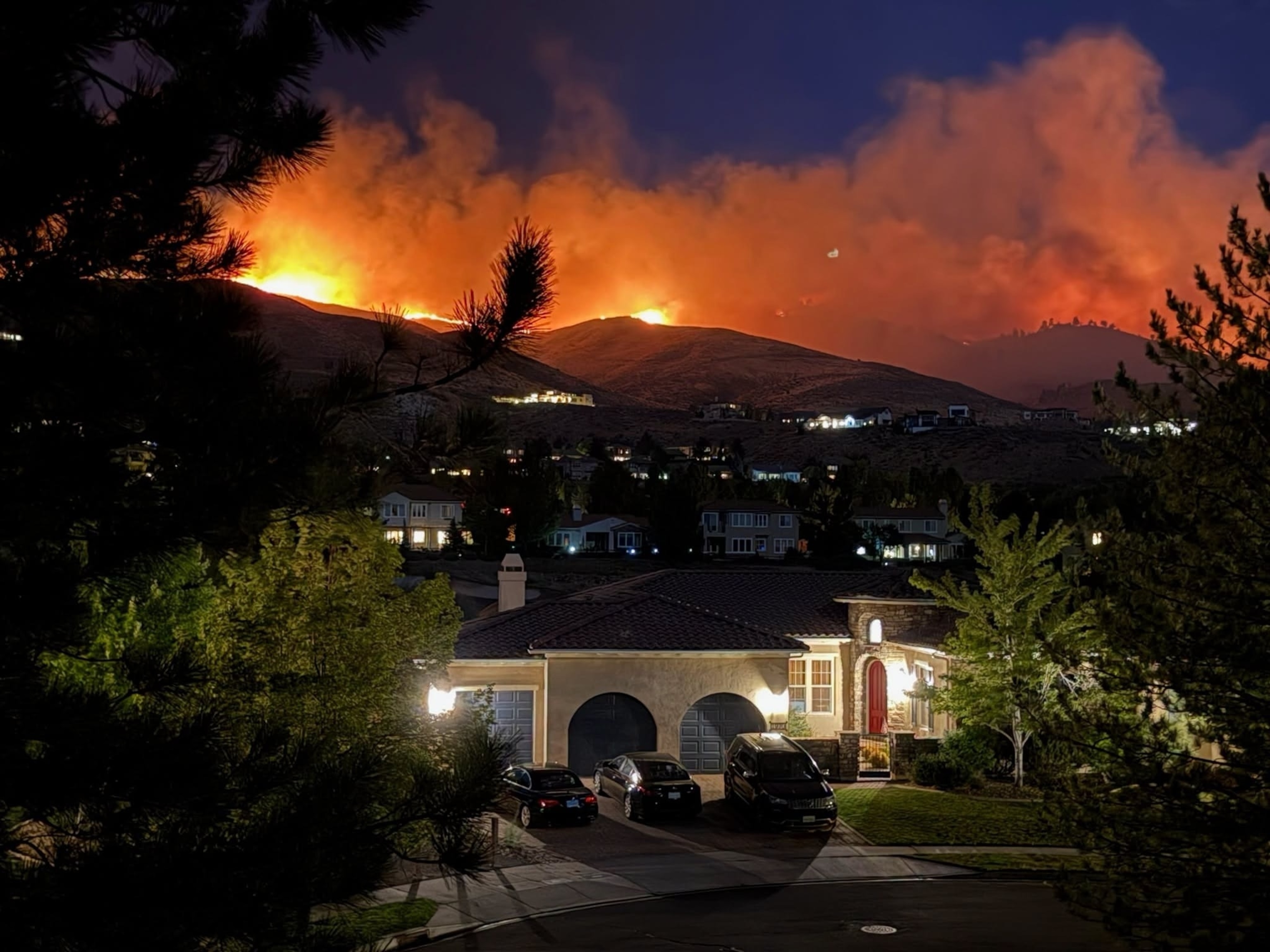 A Nevada National Guard helicopter drops water on the Hawk Fire, as the wildfire burns, near Reno, Nevada, August 23, 2026.Nevada National Guard/via Reuters
