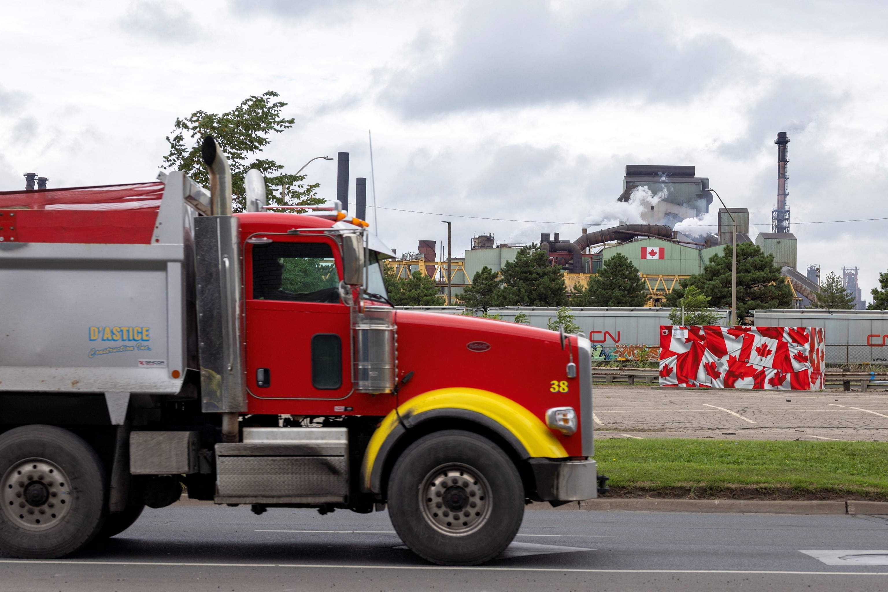 Flags adorn the ArcelorMittal Dofasco steel plant as trade tensions escalate over U.S. tariffs and retaliatory measures by Canada in Hamilton, Ontario, Canada, Aug. 24, 2026.Carlos Osorio/Reuters