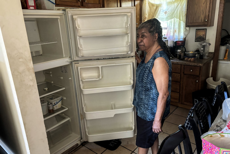 Walker stands in front of her empty fridge, where, she says, more than $700 worth of food has spoiled.Selina Guevara / NBC News