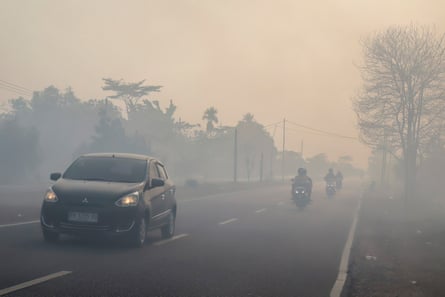 Traffic on a haze-shrouded road in Palangka Raya city, Central Kalimantan, on 20 August 2026.Photograph: REINA/AFP/Getty Images