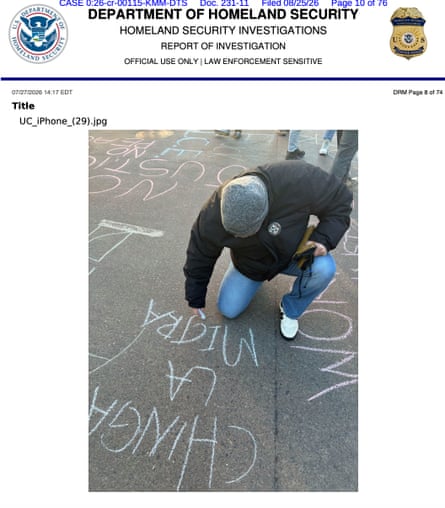 A photo by an undercover agent of a protester writing an anti-ICE message on the ground.Photograph: Department of Homeland Security