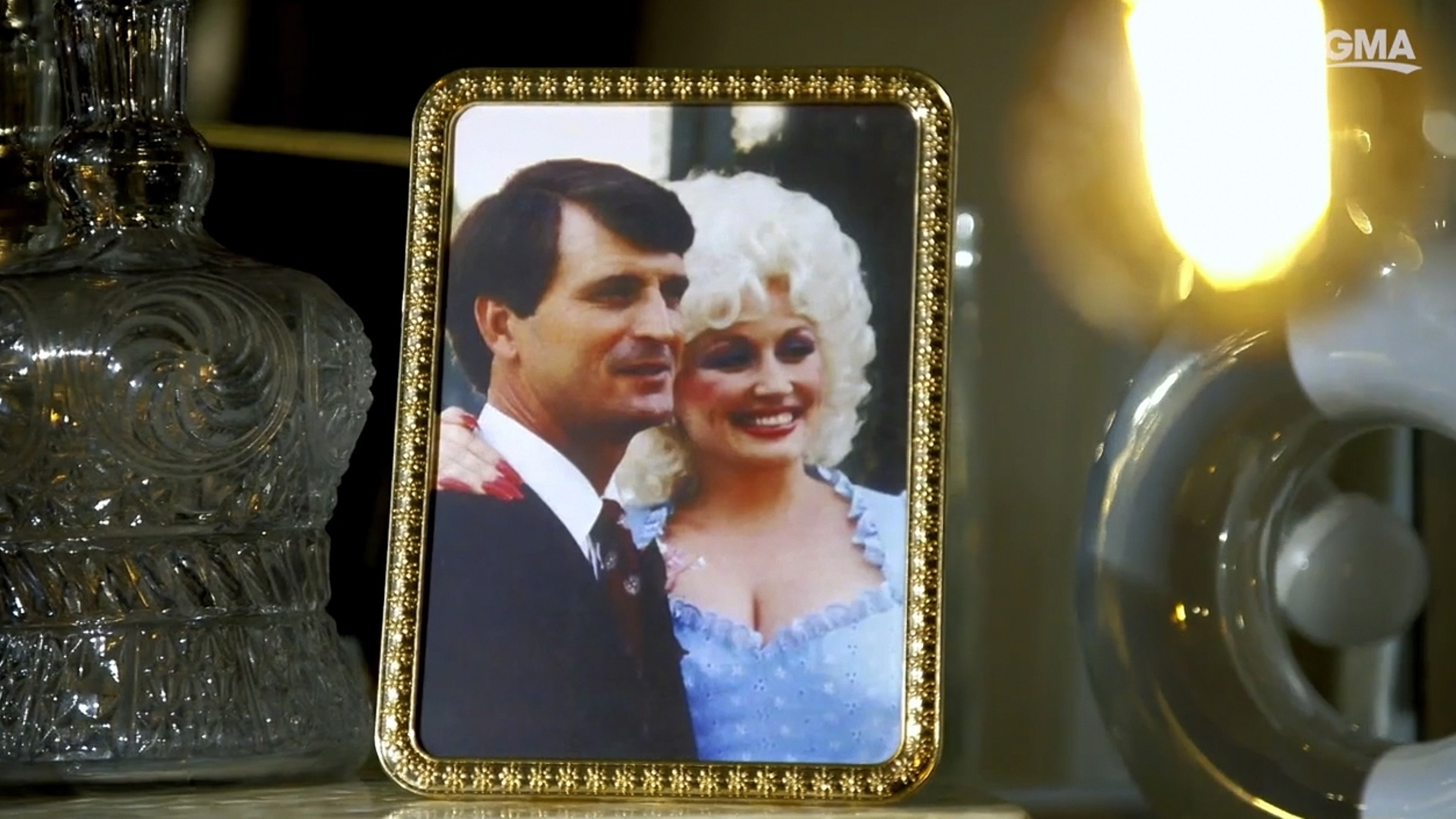 A framed photo of Dolly Parton and her husband Carl Dean stands on a table top while Parton was interviewed by ABC News in Nov. 2023.ABC News