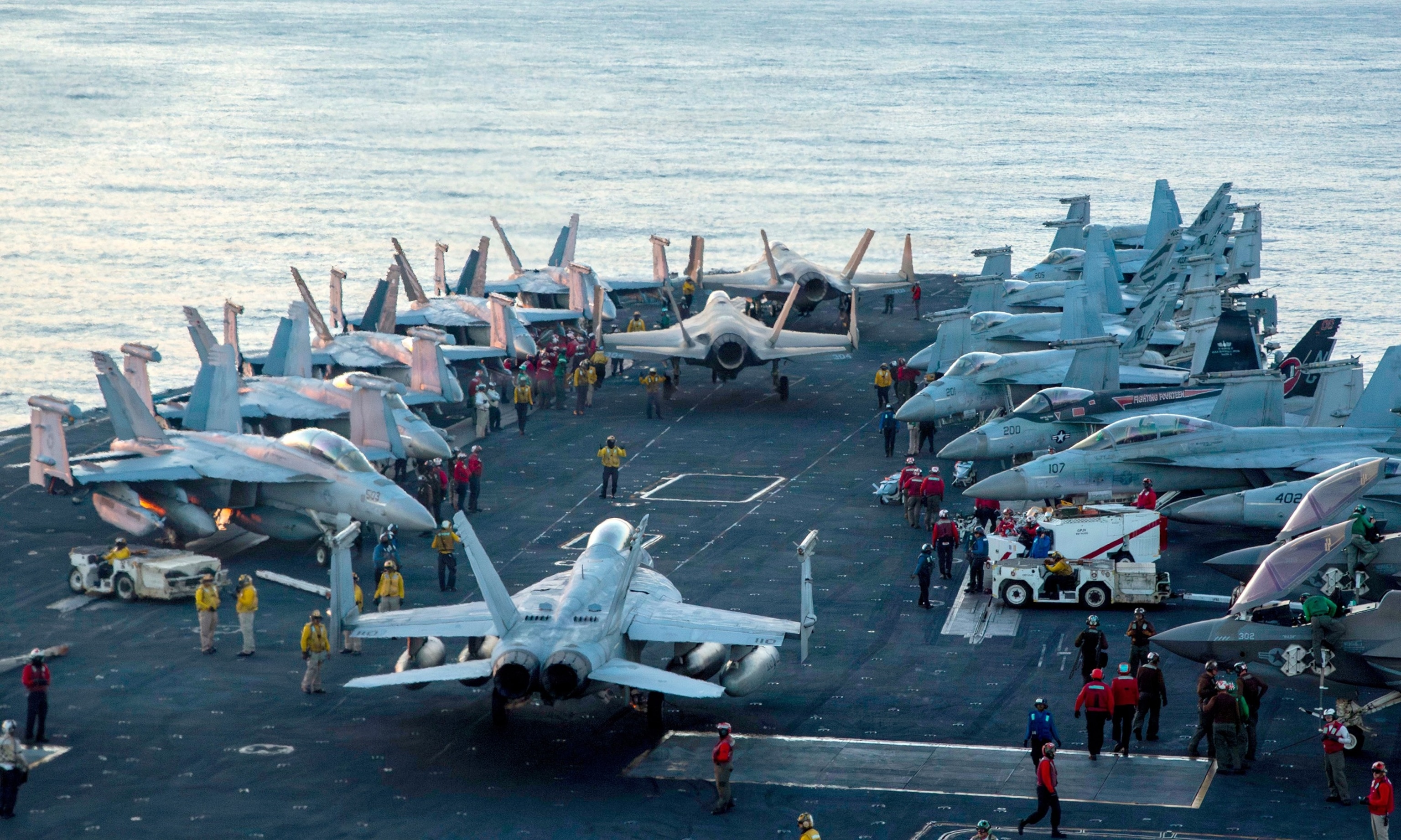 U.S. sailors taxi aircraft to a staging point on the flight deck of Nimitz-class aircraft carrier USS Abraham Lincoln, in support of Operation Epic Fury, Feb. 28, 2026.US Navy