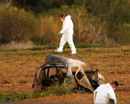 Forensics officers search the area around Daphne Caruana Galizia’s car in October 2017.Photograph: Darrin Zammit Lupi/Reuters
