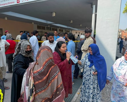 Relatives of the children who died in the fire gather at the hospital.Photograph: M Yousaf/AP