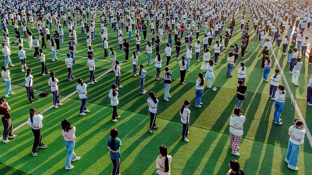 Image caption,Students practise yoga to relieve stress before the competitive annual college entrance exam