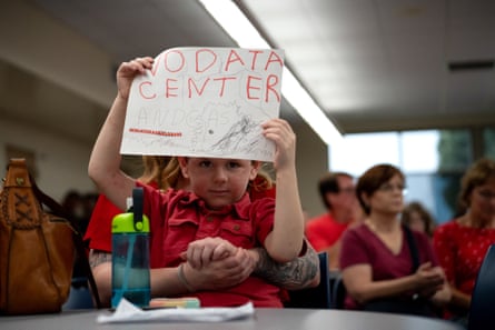 A child holds a ‘No Data Center’ sign during a public meeting in Ashville, Ohio, on 19 August.Photograph: Bloomberg/Getty Images