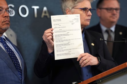 Mary Moriarty, a Hennepin county attorney, holds up a document containing charges against ICE agent Christian Castro during a news conference at the Hennepin county government center in Minneapolis, on 18 May 2026.Photograph: Renée Jones Schneider/Minnesota Star Tribune/AP