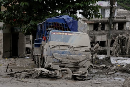 A vehicle covered in mud in Trishuli, Nepal.Photograph: Navesh Chitrakar/Reuters