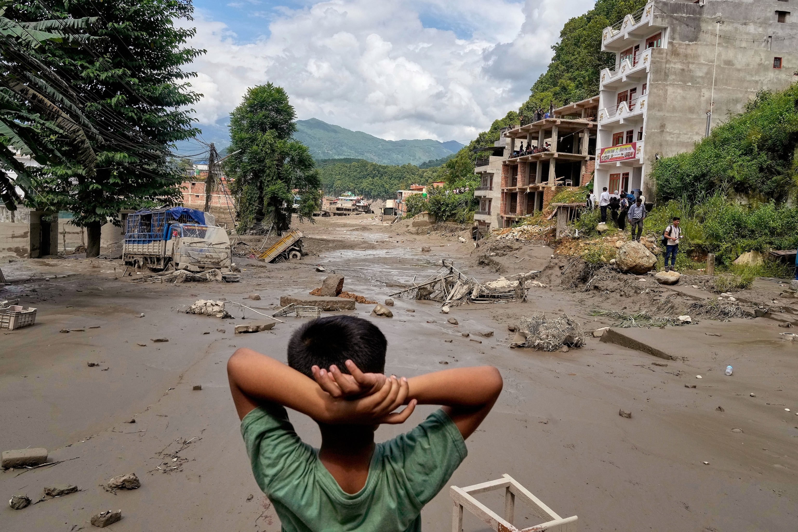 A boy looks at the devastation caused by flash flooding along the Trishuli River in Nepal's Nuwakot district, Aug. 26, 2026.Niranjan Shrestha/AP Photo