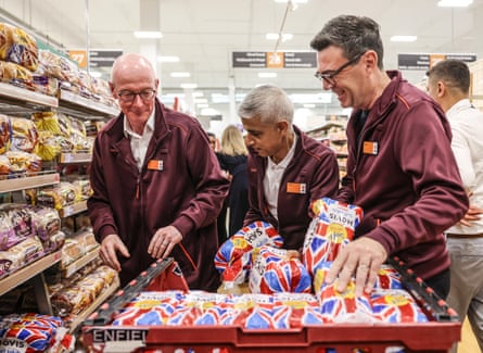 Pat McFadden, Sadiq Khan and Andy Burnham help to stack shelves at Sainsbury’s in Nine Elms, London.Photograph: Richard Pohle/Reuters
