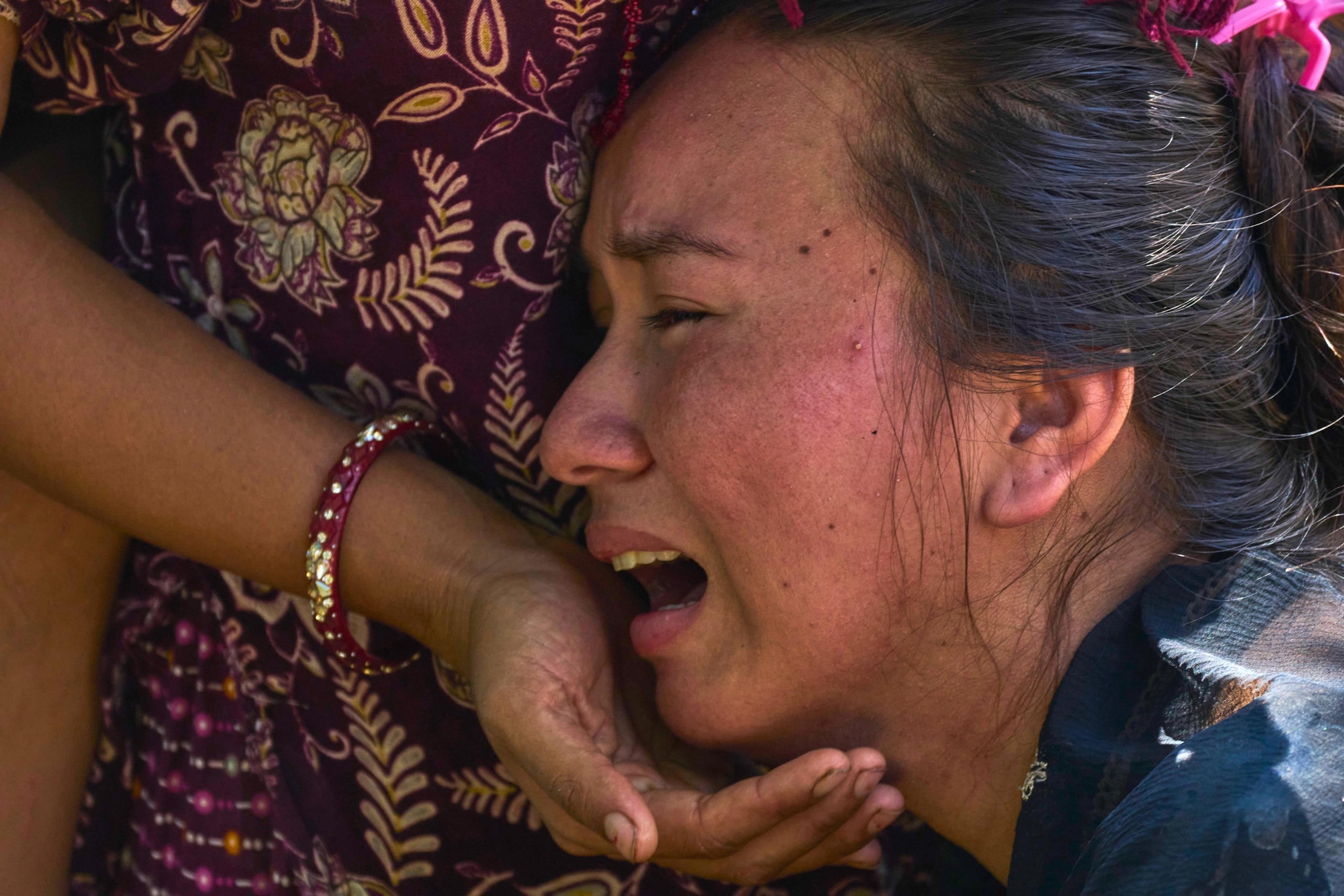A girl cries as she waits for news of relatives missing after flash floods in Bidur, Nepal's Nuwakot district, Aug. 27, 2026.Niranjan Shrestha/AP Photo