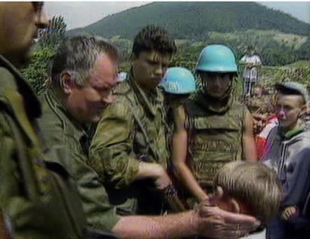 A screengrab from 12 July 1995 shows Mladić speaking to a young Muslim boy after he had assured residents of Srebrenica they would be safe.Photograph: AP