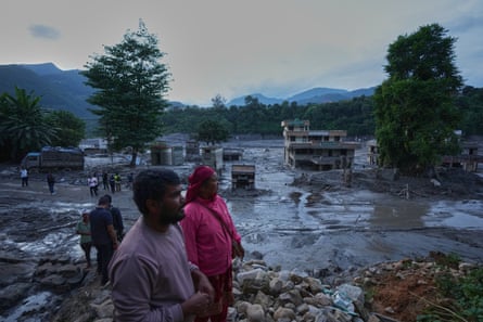 People look at the devastation left by flash flooding in Nepal’s Nuwakot district.Photograph: Rajesh Kumar Singh/AP