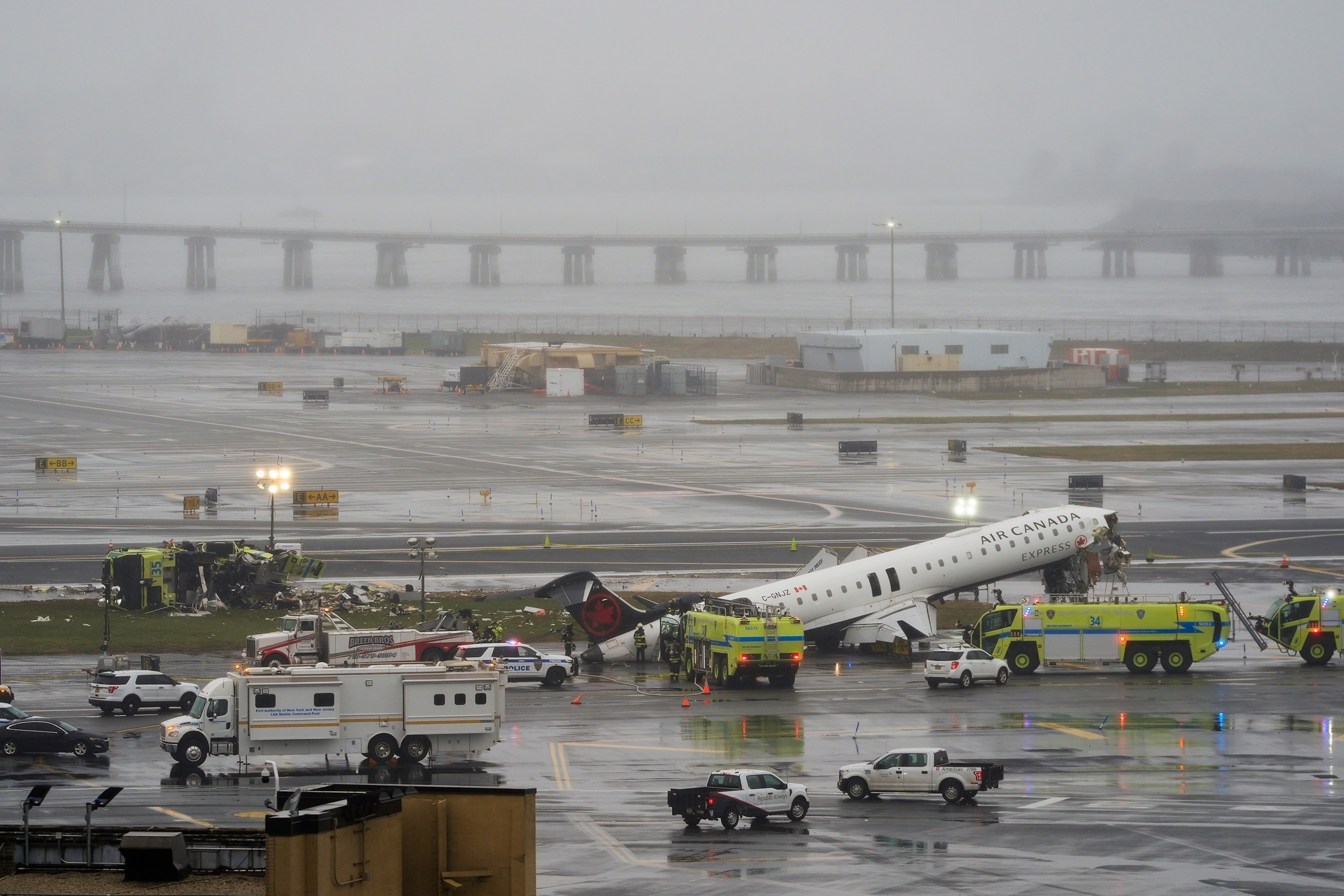 An Air Canada jet and Port Authority fire truck sit on the runway at LaGuardia Airport, March 23, 2026, after colliding with each other after the Jet landed Sunday night in New York.Seth Wenig/AP