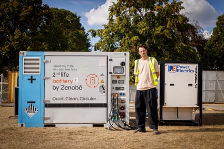 Ben Price stands by a Zenobe second life battery, charged with local renewable energy, which will power some of the smaller festival areas.Photograph: Alicia Canter/The Guardian