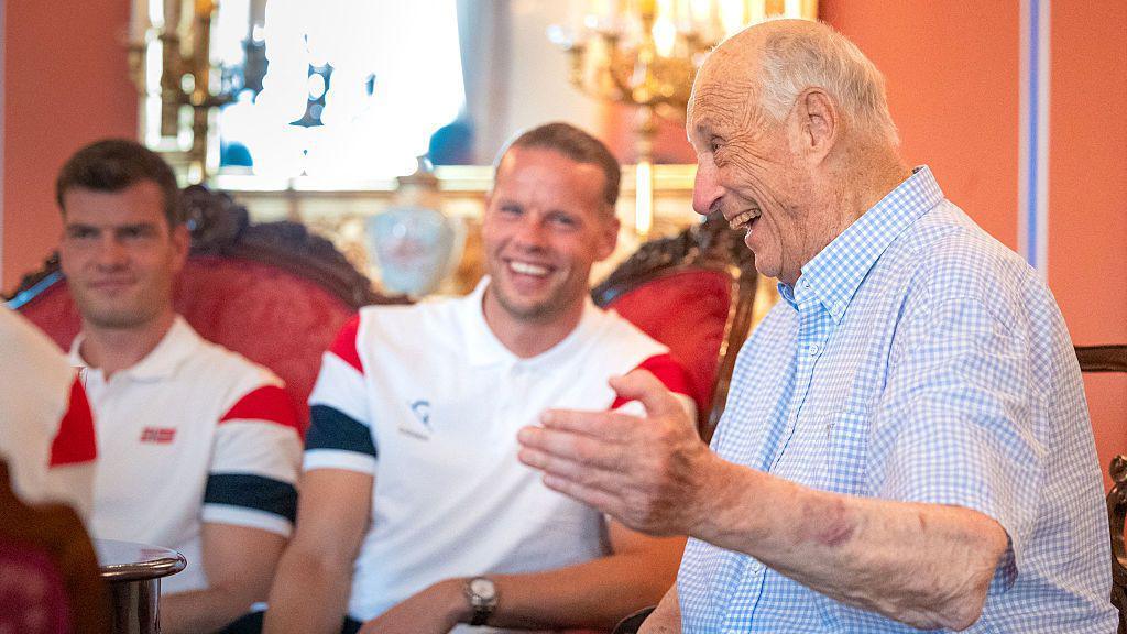 Image caption,King Harald welcomed the Norwegian national football team to the palace after they made it to the quarter-finals of the World Cup for the first time this year