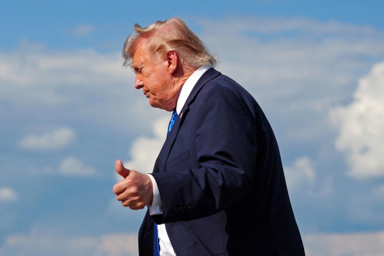 President Donald Trump flashes a thumbs-up while stepping off Air Force One on July 31.Aaron Schwartz / AFP via Getty Images file