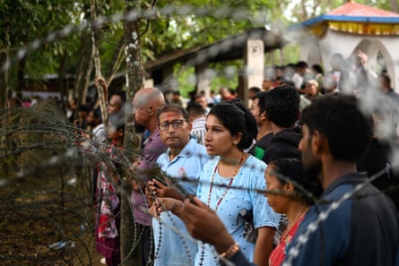 People wait for information about their missing relatives outside a military camp in the Trishuli area of Nepal’s Nuwakot district.Photograph: Manan Vatsyayana/AFP/Getty