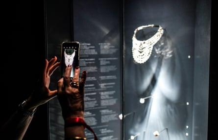 A visitor takes a picture of the platinum and diamond necklace, which dates from 1939 and belonged to Queen Nazli of Egypt, at the Pierres Précieuses exhibition in Paris.Photograph: Stéphane de Sakutin/AFP/Getty