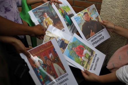 Relatives display photos of missing people outside a hospital in Kathmandu, where they have travelled from Rasuwa to seek information about family members.Photograph: Subaas Shrestha/NurPhoto/Shutterstock