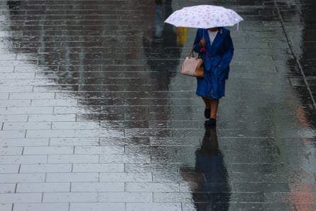 The heavy rain follows weeks of exceptionally dry weather in England. Pictured: a woman in Liverpool.Photograph: Adam Vaughan/EPA