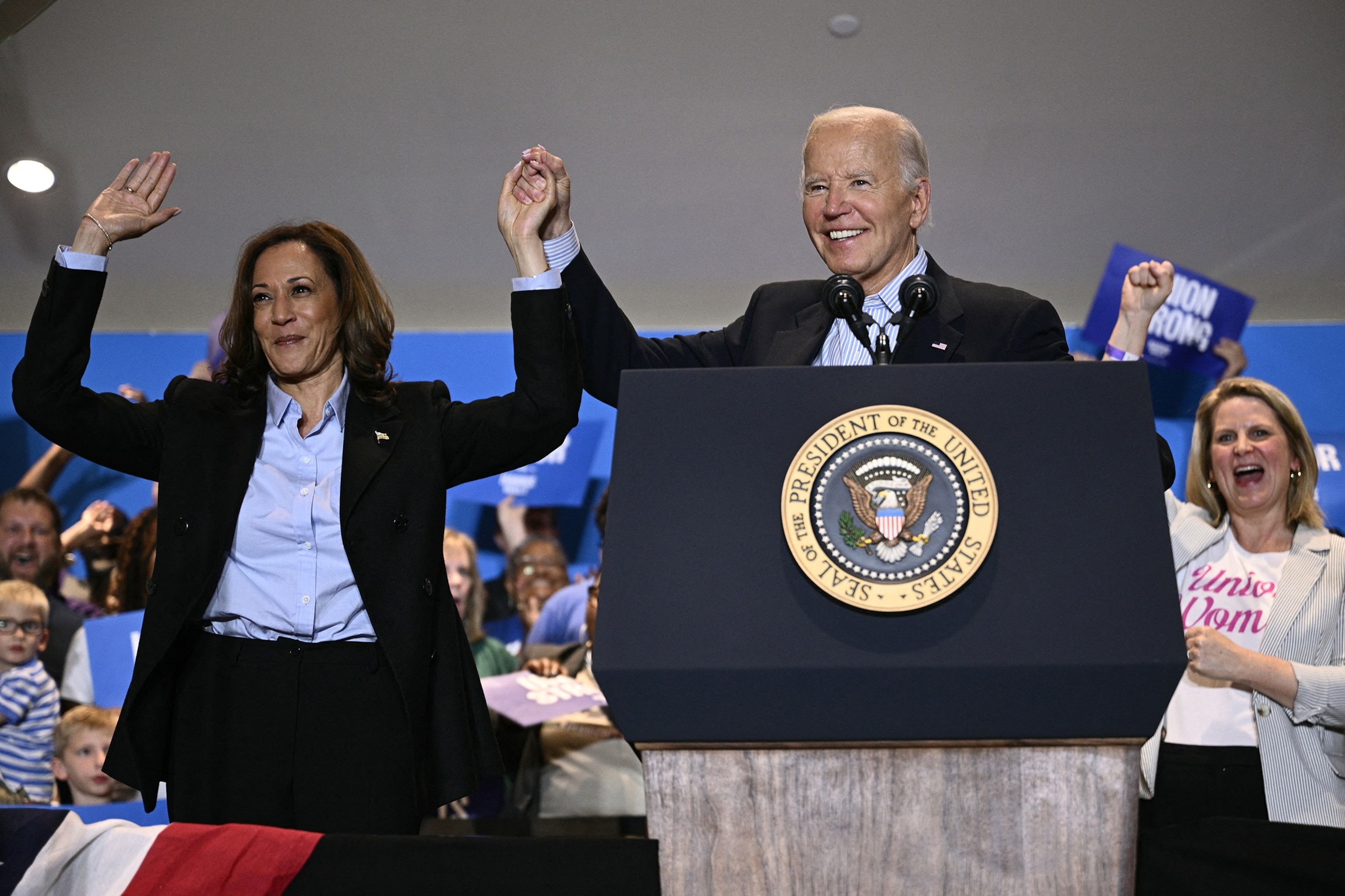 In this Sept 2, 2024, file photo, President Joe Biden holds up Vice President and Democratic presidential candidate Kamala Harris's hand during a campaign rally at the International Brotherhood of Electrical Workers (IBEW) Local 5 in Pittsburgh, Pennsylvania.Brendan Smialowski/AFP via Getty Images, FILE