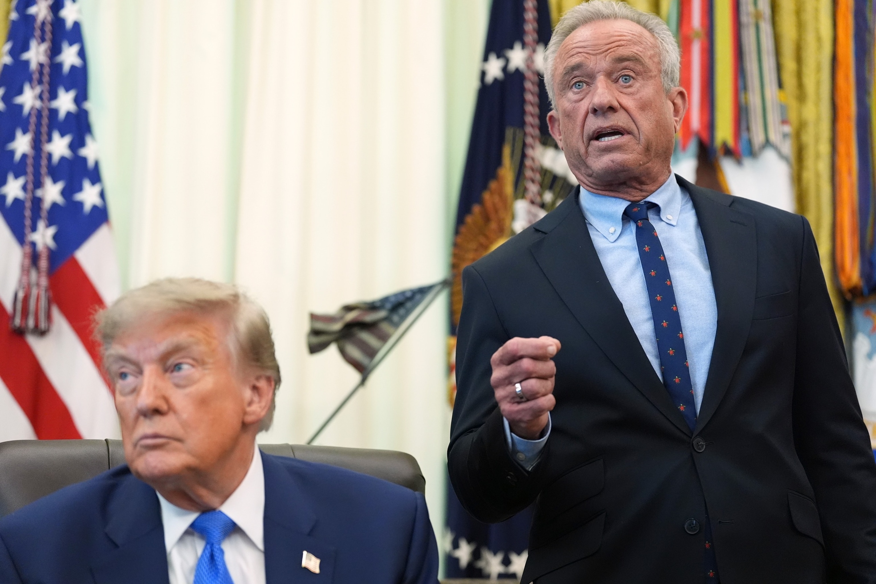 Health and Human Services Secretary Robert F. Kennedy Jr. speaks as President Donald Trump listens during a meeting about vaccines, Aug. 10, 2026, in the Oval Office of the White House in Washington.Jacquelyn Martin/AP Photo